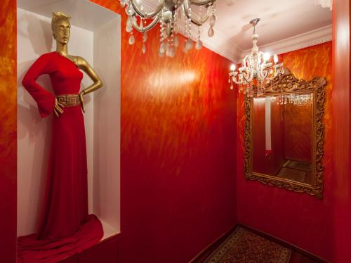 a mannequin in a red dress in a room with a mirror at Acropolis Museum Boutique Hotel in Athens