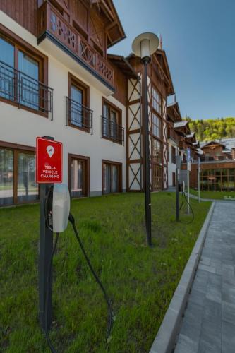 a building with a meter in the grass in front of it at Szczawnica Park Resort & Spa in Szczawnica