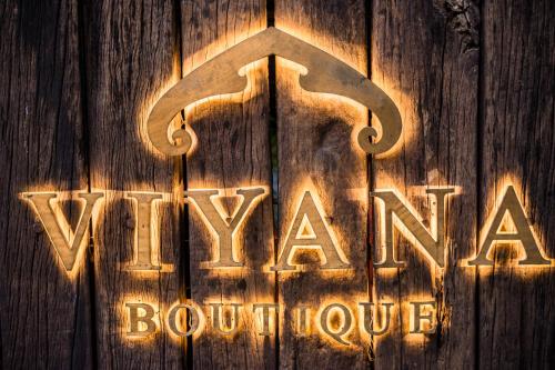 a neon sign that says vaxoorooroorroute at Viyana Boutique Hotel in Kandy