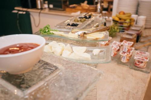 a table with several trays of food and a bowl at Boulevard Hotel Batumi in Batumi