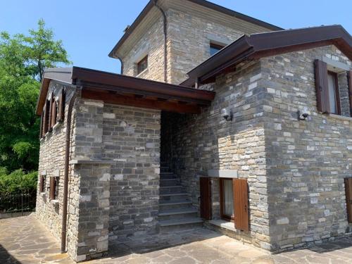 a brick house with stairs on the side of it at Borgo Scorza in Pietramogolana