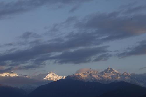 a view of a mountain range under a cloudy sky at Sikkim Tourist Centre in Pelling