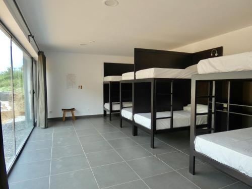 a dorm room with four bunk beds in it at Albergue Casa Sueño in Salas