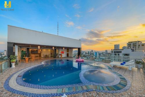 a swimming pool on the roof of a building at Merry Land Hotel Da Nang in Da Nang