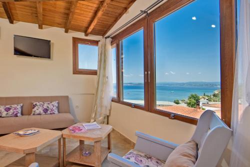 a living room with a view of the ocean at Archodiko Toliadi Boutique Apartments and Suites in Ouranoupoli