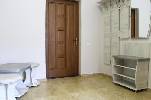 a room with a door and a table and a desk at Kvasova Voda in Polyana
