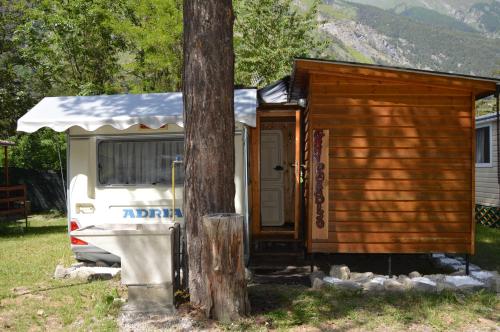 a tiny house next to a tree next to a tree at Camping Du Parc in Pré-Saint-Didier