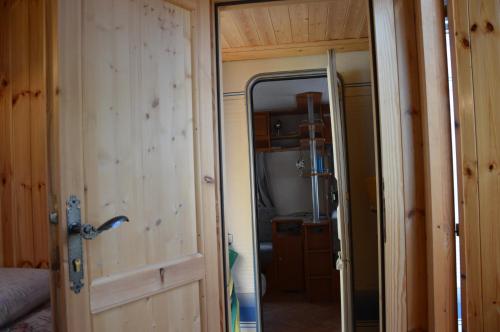 an open door to a bedroom in an rv at Camping Du Parc in Pré-Saint-Didier