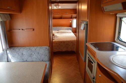 a small room with a bed and a sink at Camping Du Parc in Pré-Saint-Didier