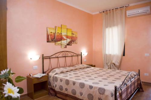 a bedroom with a large bed and a window at Villa Terra Nostra in Vieste