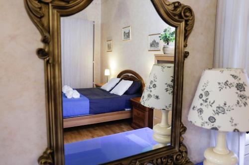 a bedroom with a bed and a mirror at Domus Titiana Amazing Apartment in Trastevere in Rome