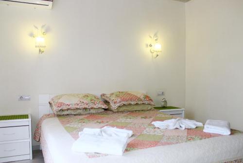 a bedroom with a bed with towels on it at Kvasova Voda in Polyana