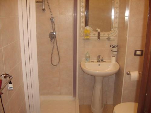 a bathroom with a shower and a sink at B&B Valoroso Village in Licata