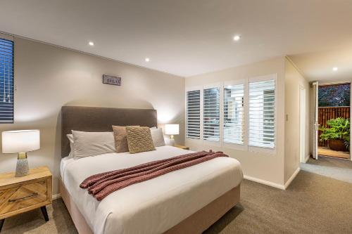 
a bedroom with a large bed and a large window at Prideau's of Margaret River in Margaret River Town
