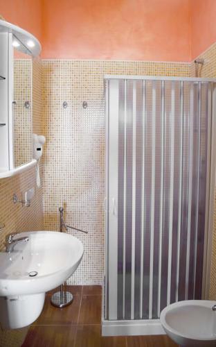 a bathroom with a white sink and a shower at Villa Terra Nostra in Vieste