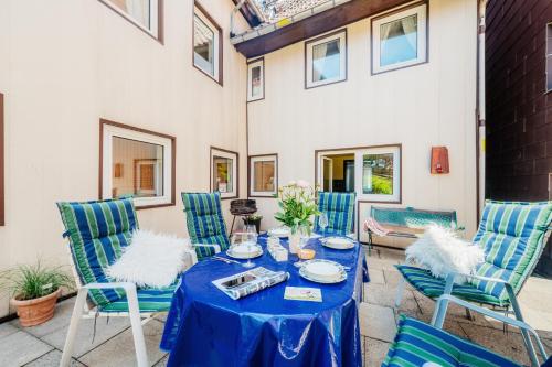 a patio with a blue table and chairs at Ferienhaus St. Andreasberg in Sankt Andreasberg