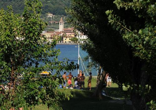 a group of people on a beach near a body of water at Iseo Lago Hotel in Iseo