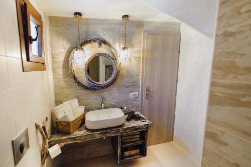 a bathroom with a sink and a mirror at Marilias Apartment in Kamari