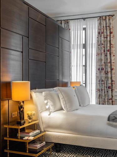 a bedroom with a large bed with a large headboard at J.K. Place Paris in Paris