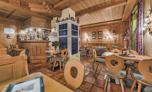a restaurant with tables and chairs in a room at Landgasthaus & Hotel Kurfer Hof in Bad Endorf