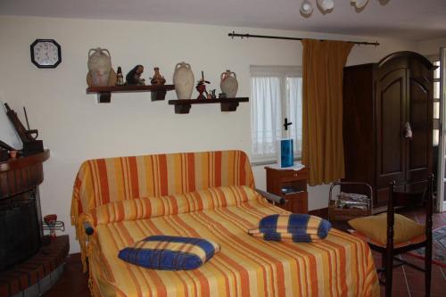 a bedroom with a bed with two pillows on it at Villa Orlando in Bova Marina