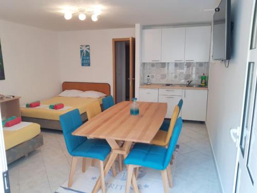 a kitchen and dining room with a wooden table and chairs at Villa Star in Drvenik