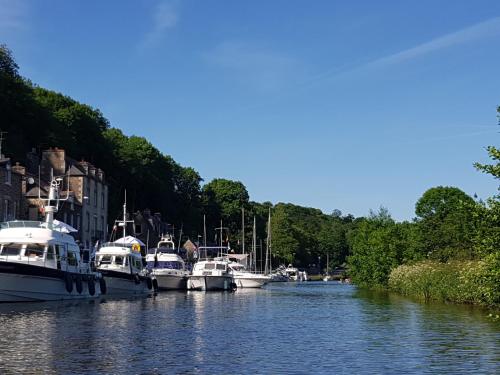 a group of boats are docked in a river at Le Grand Domaine du Rocher in Bonnemain