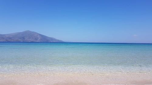 a beach with the ocean and mountains in the background at Bonbon Sea Apartment in Orikum