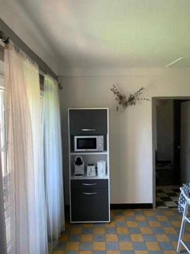 a living room with a microwave and a window at Clos Augusta in Riez