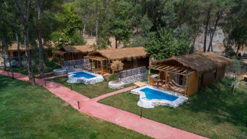 an aerial view of a house with a swimming pool at Suna Village Hotel & Bungalow Fethiye in Fethiye
