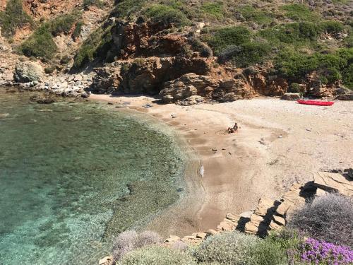 a beach with people on the sand and the water at Hersonissos Andros in Gavrion