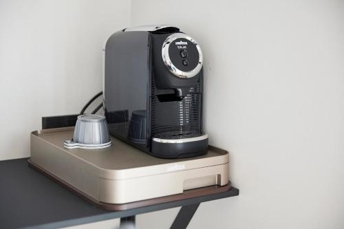 a black appliance sitting on top of a shelf at Hotel Skjern in Skjern