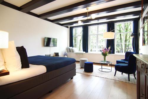 a bedroom with a bed and a living room at 1637: Historic Canal View Suites in Amsterdam