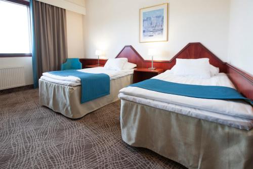 En eller flere senge i et værelse på Hotel Oscar