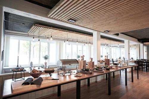 a large room with a long table with items on it at Hotel Skjern in Skjern