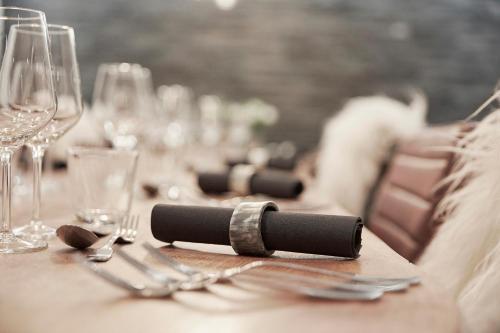 a table with glasses and silverware on top of it at Hotel Skjern in Skjern