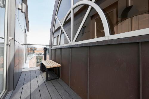 a bench sitting on the balcony of a building at Hotel Skjern in Skjern