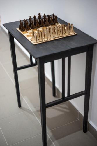 a table with a chessboard on top of it at Servus Vendégház in Lengyeltóti
