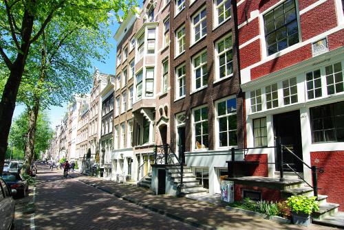a city street with a large brick building at 1637: Historic Canal View Suites in Amsterdam