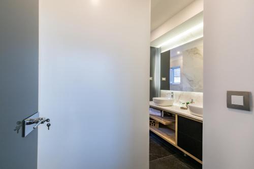 a bathroom with two sinks and a mirror at Downtown Marcius Luxury Apartment with Jacuzzi & Sauna in Zadar