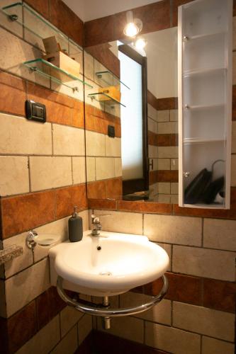 a bathroom with a white sink and a mirror at B&B Trepo in Tropea