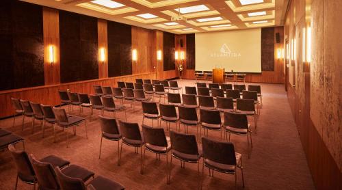 a conference room with chairs and a screen in it at Atlantida Boutique Hotel in Rogaška Slatina