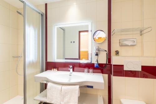 a bathroom with a sink and a shower at Austria Classic Hotel Wien in Vienna