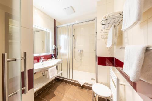 a bathroom with a sink and a shower at Austria Classic Hotel Wien in Vienna