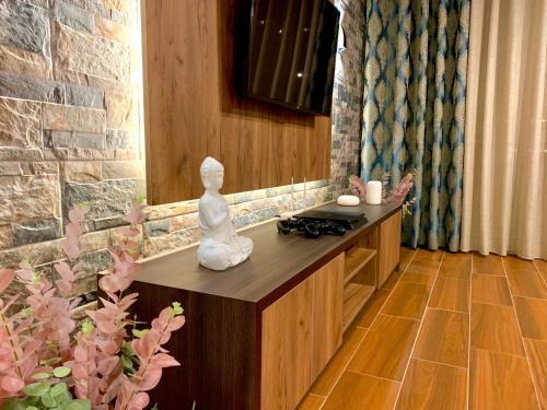 a room with a statue sitting on a counter at EKA Luxury Two-Bedroom Premium Apartment 2 in Durrës