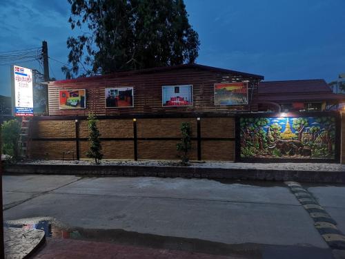 a building with paintings on the side of it at Baan Sabaijai Resort in That Phanom