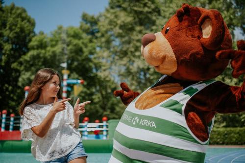 a woman is standing next to a stuffed animal at Hotel Balnea Superior - Terme Krka in Dolenjske Toplice