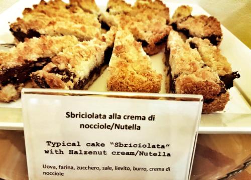 a plate of food with a sign in front of it at Palace Hotel Due Ponti in Siena