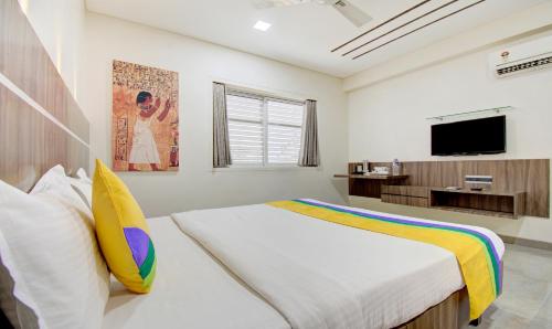 a bedroom with a bed and a flat screen tv at Treebo Lalaji's Executive in Aurangabad