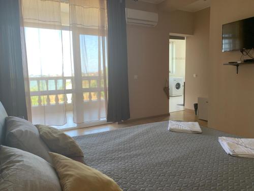 a bedroom with a large bed and a large window at La Cer in Constanţa